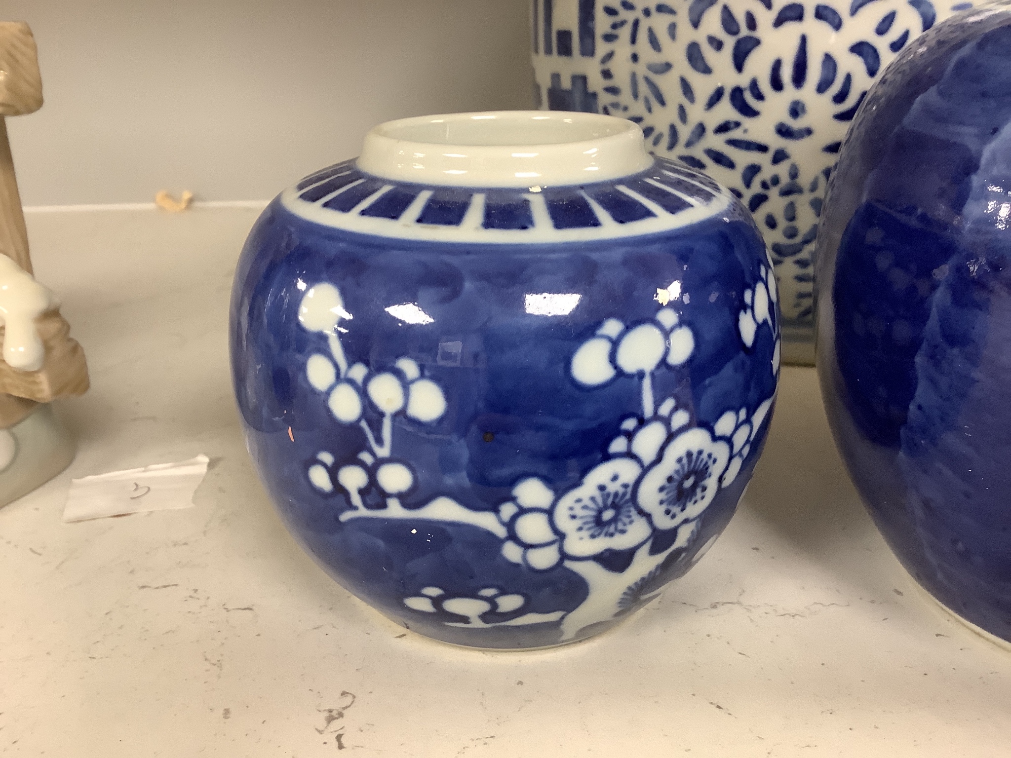 Four Chinese blue and white ginger jars, one with cover, tallest 23cm